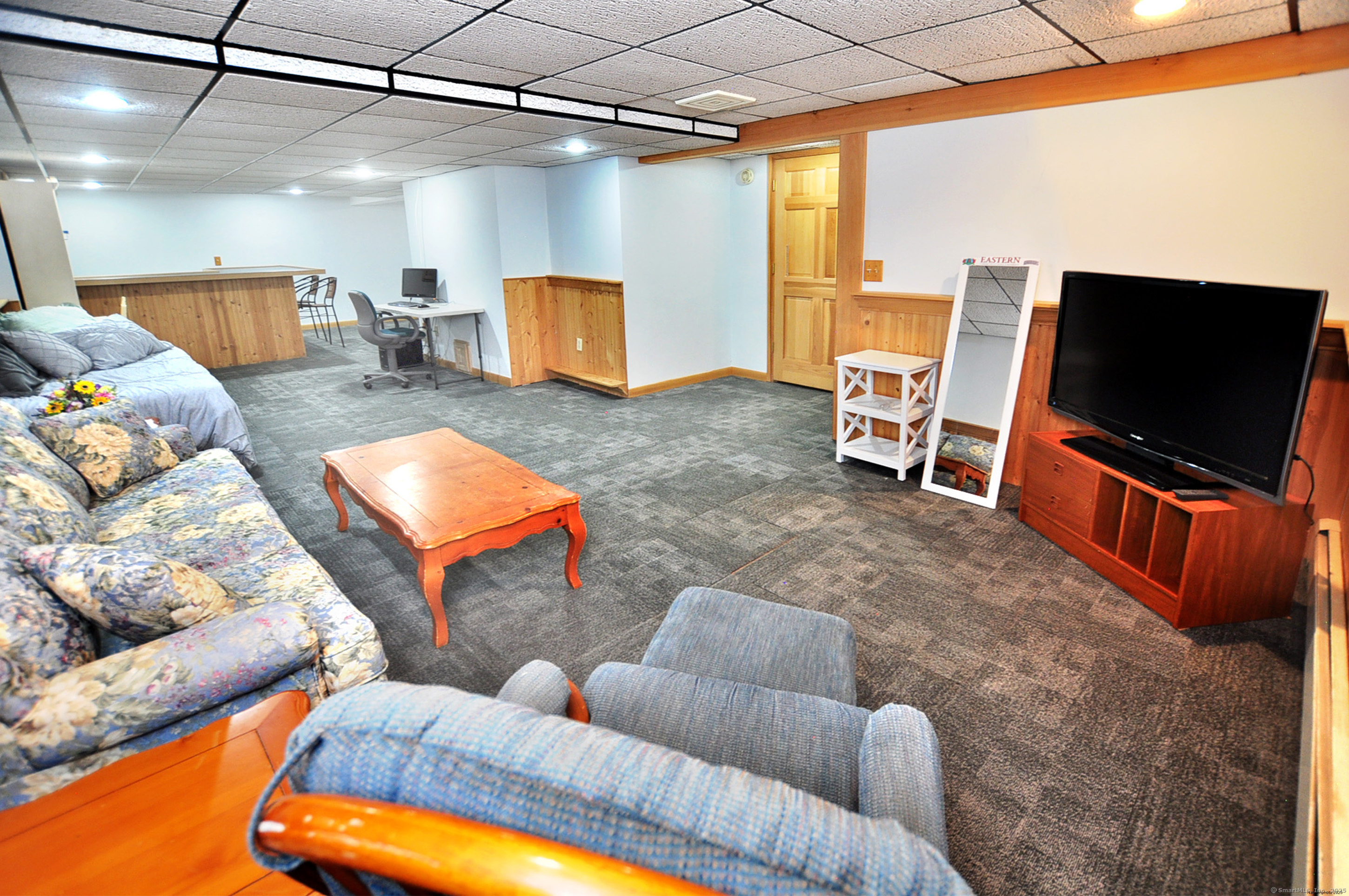 18 Fiano Road Bolton, CT 06043 - Photo 33 of 38 a living room with furniture and a flat screen tv