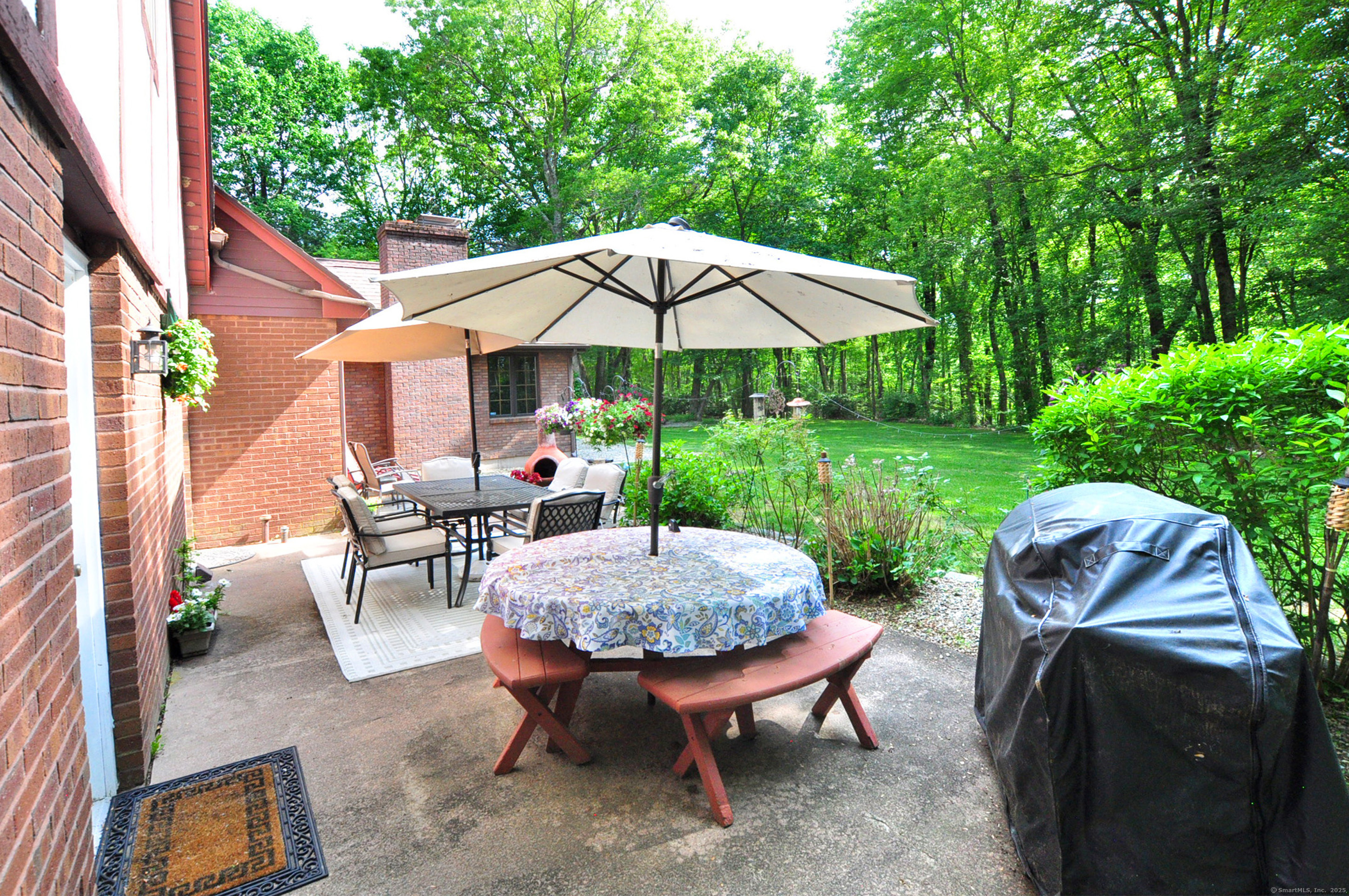 18 Fiano Road Bolton, CT 06043 - Photo 38 of 38 a view of a patio with table and chairs under an umbrella