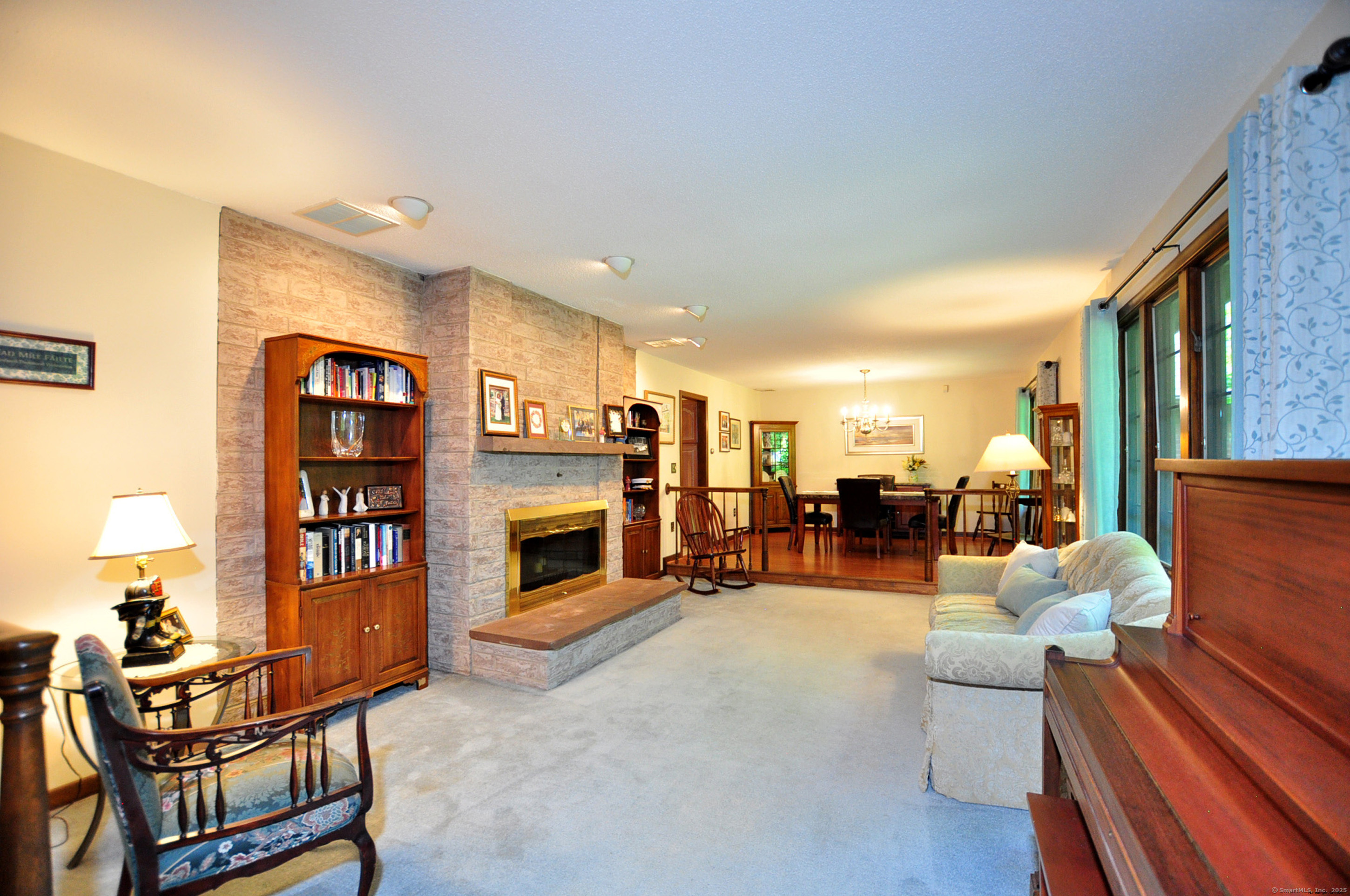 18 Fiano Road Bolton, CT 06043 - Photo 7 of 38 a living room with fireplace furniture and a flat screen tv