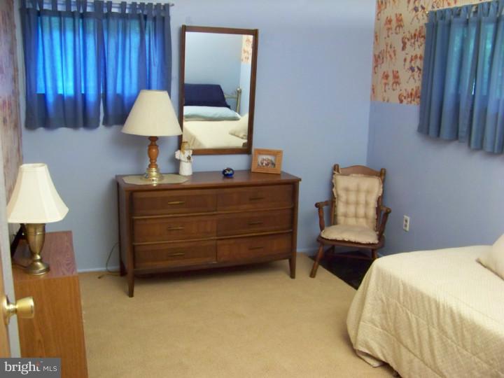 327 Evergreen Road Mount Laurel, NJ 08054 - Photo 11 of 17 a bedroom with a bed and a lamp