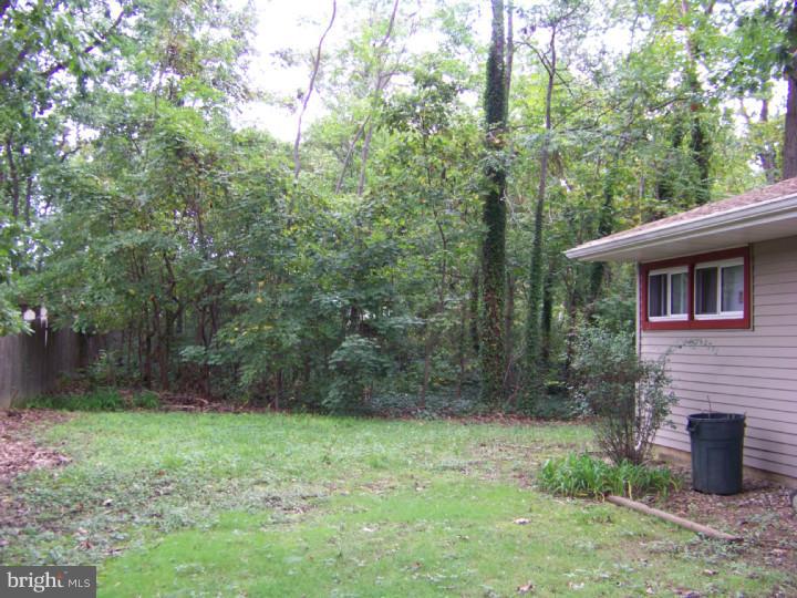 327 Evergreen Road Mount Laurel, NJ 08054 - Photo 17 of 17 a backyard of a house with lots of green space and fountain