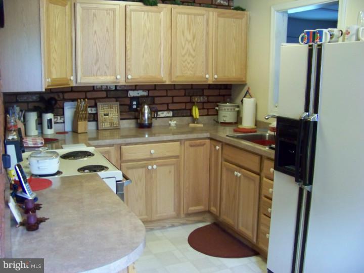 327 Evergreen Road Mount Laurel, NJ 08054 - Photo 3 of 17 a kitchen with a sink and a stove top open