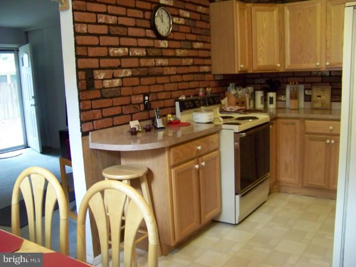 327 Evergreen Road Mount Laurel, NJ 08054 - Photo 4 of 17 a kitchen with a sink and a refrigerator