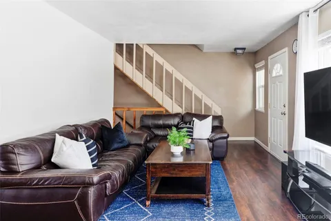 a living room with furniture rug and a flat screen tv