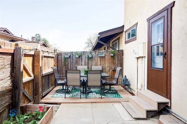 a view of patio with a table and chairs and wooden floor
