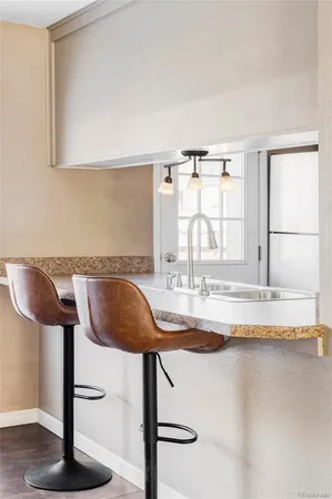 a view of a kitchen with granite countertop counter top space and a window