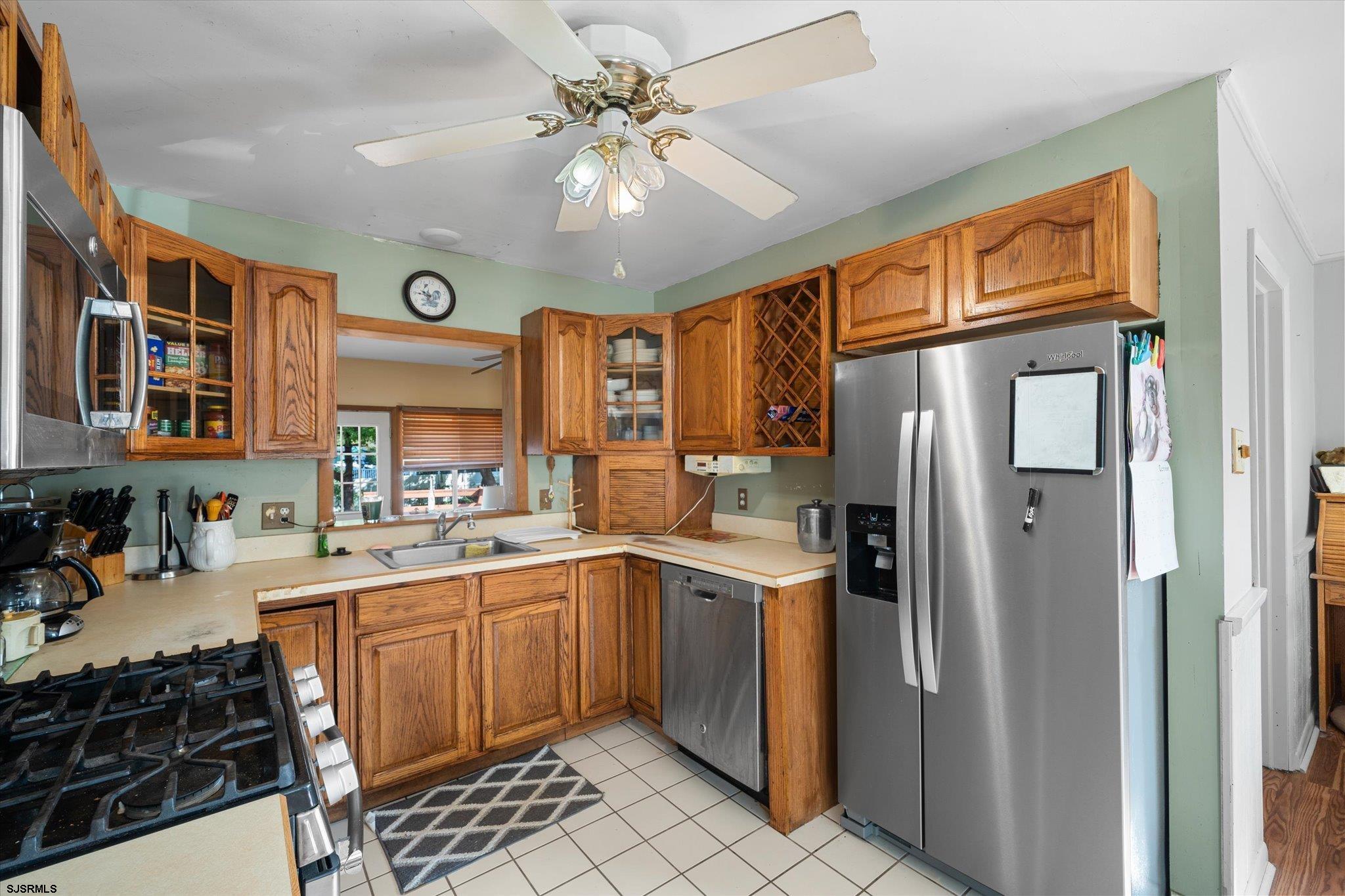 308 Pine Street Absecon, NJ 08201 - Photo 12 of 35 a kitchen with stainless steel appliances a sink a stove a refrigerator and cabinets