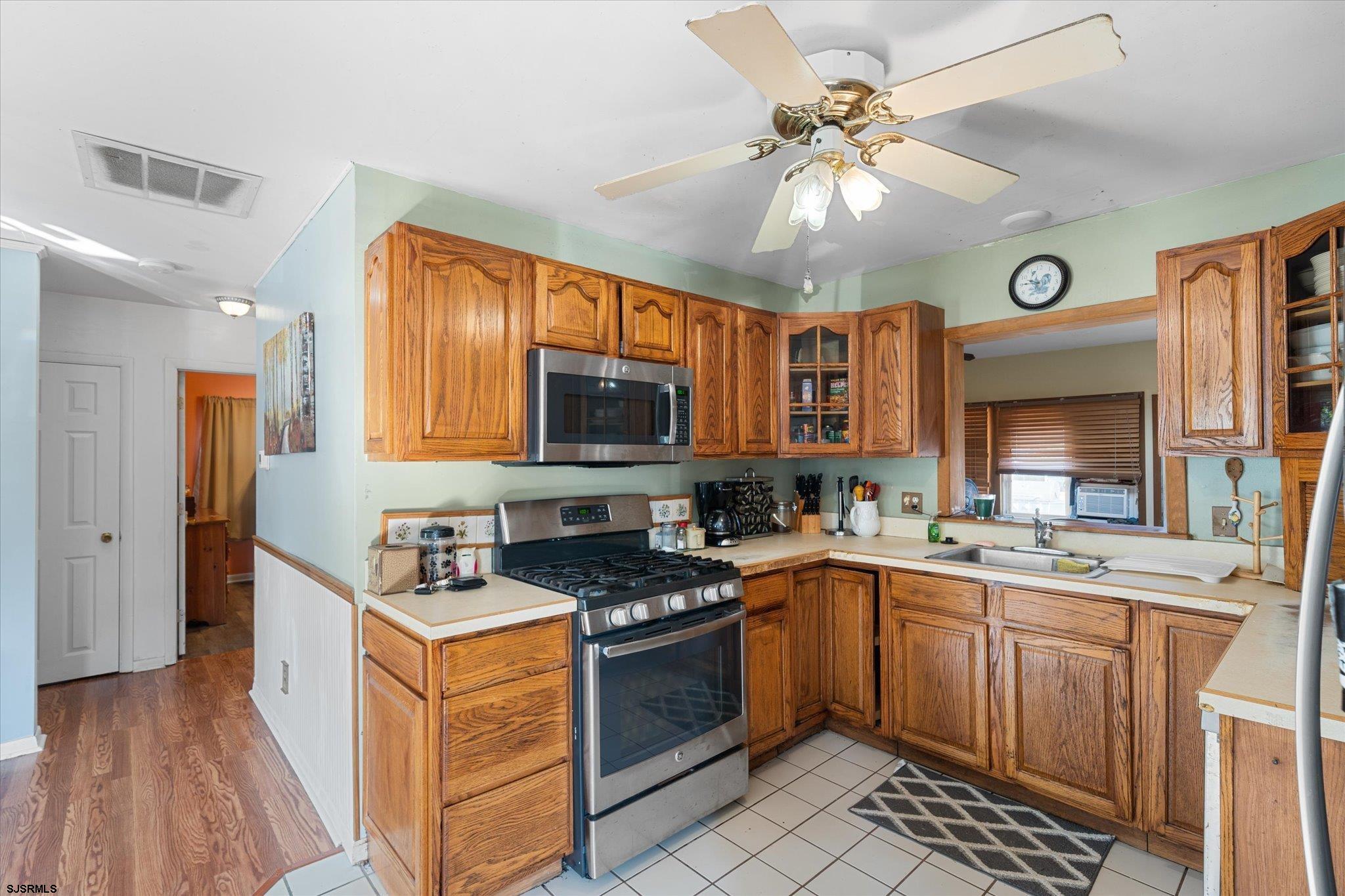 308 Pine Street Absecon, NJ 08201 - Photo 13 of 35 a kitchen with a sink stove and cabinets