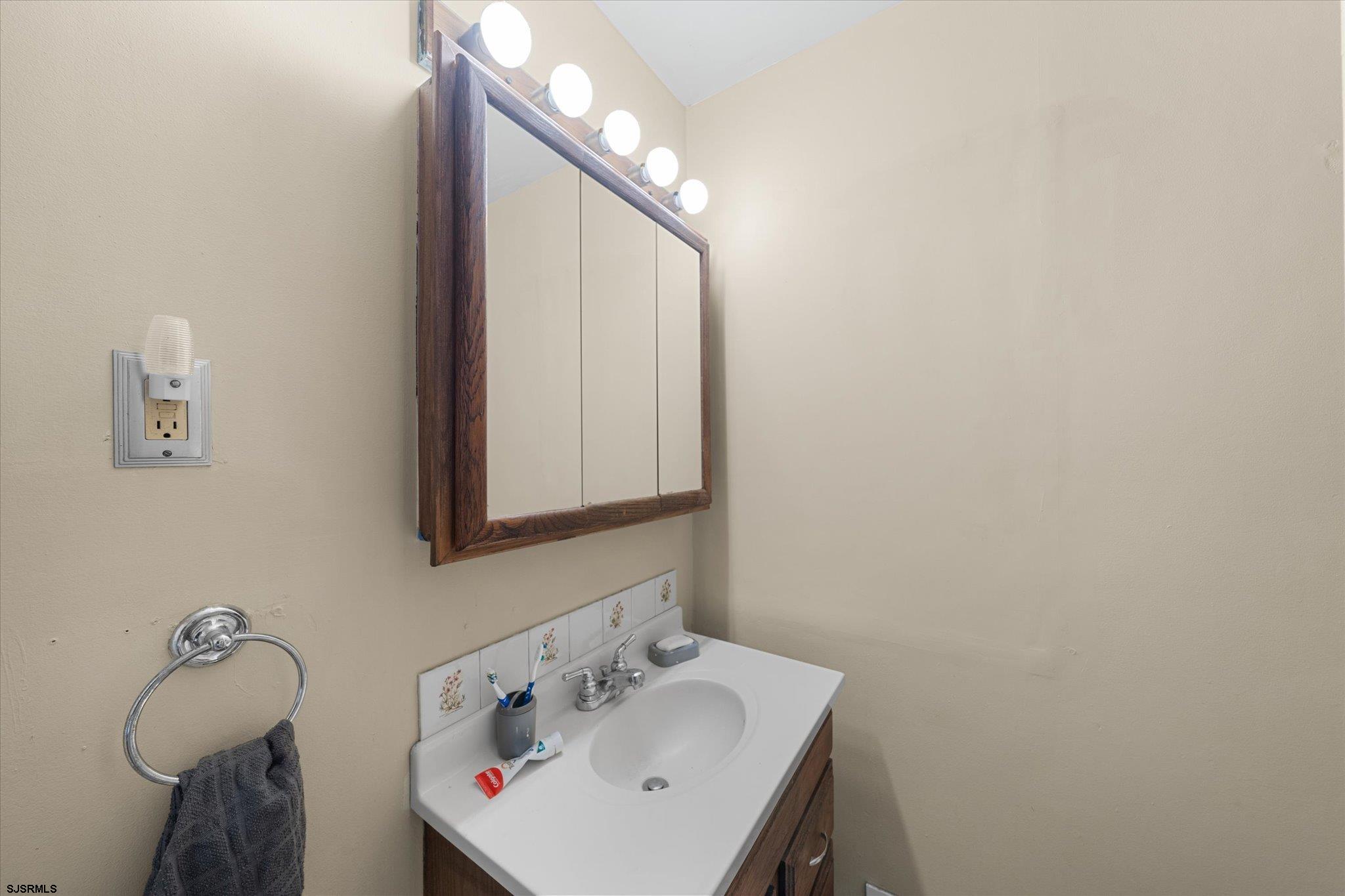 308 Pine Street Absecon, NJ 08201 - Photo 19 of 35 a bathroom with a sink and mirror