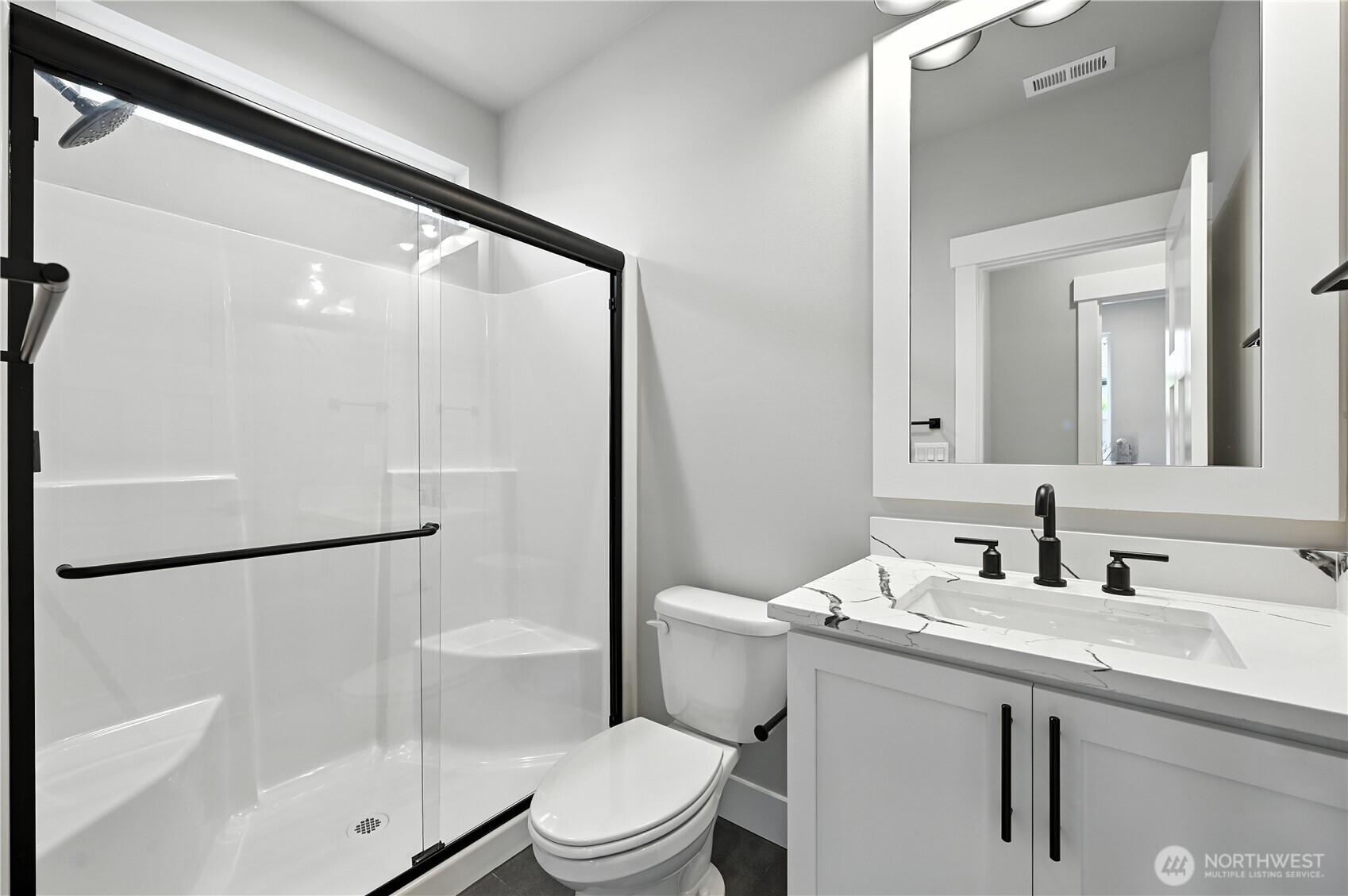 19225 Meridian Drive Southeast, Unit CW 15 Bothell, WA 98012 - Photo 14 of 31 a bathroom with a sink a mirror toilet and shower