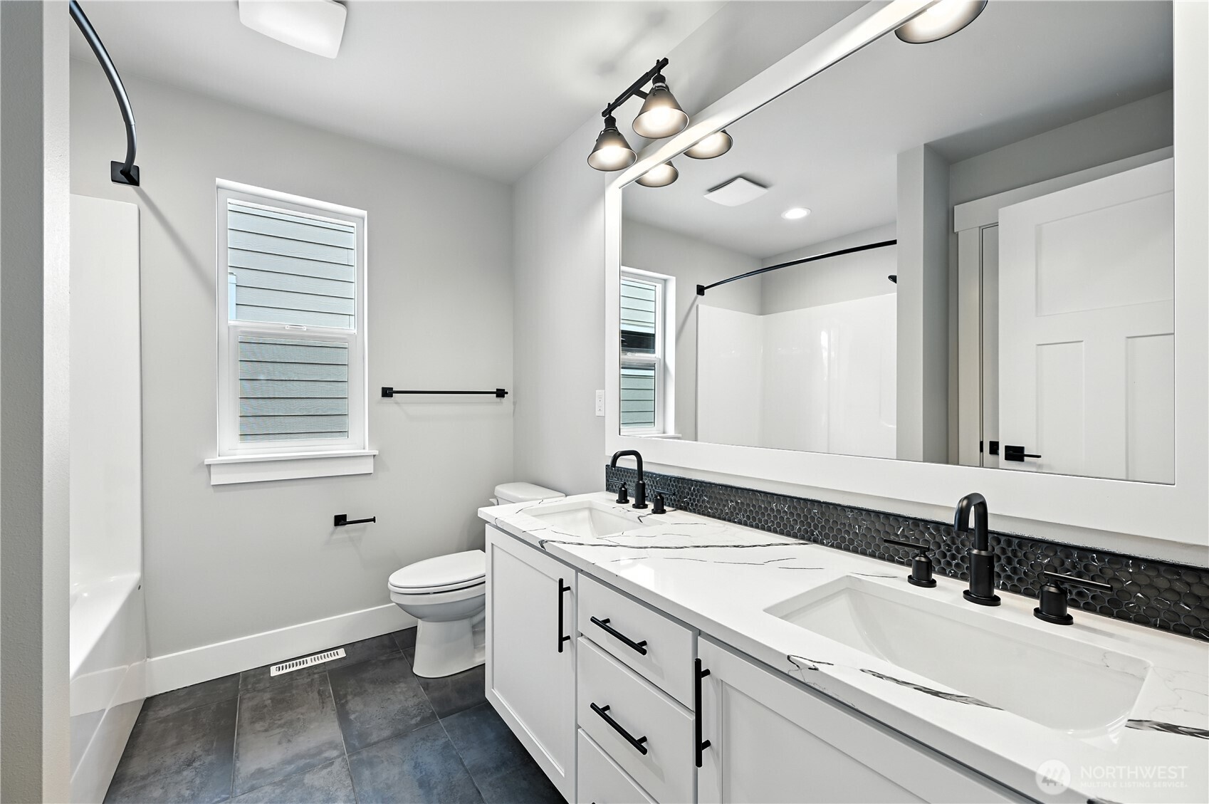 19225 Meridian Drive Southeast, Unit CW 15 Bothell, WA 98012 - Photo 25 of 31 a bathroom with a double vanity sink toilet and mirror