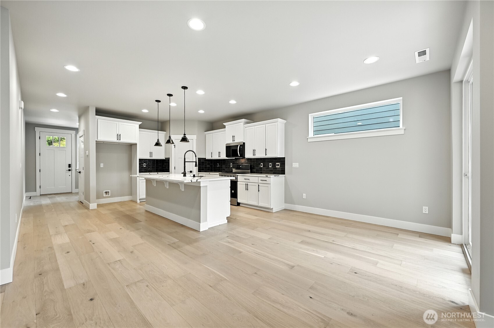 19225 Meridian Drive Southeast, Unit CW 15 Bothell, WA 98012 - Photo 4 of 31 a large white kitchen with stainless steel appliances kitchen island granite countertop a refrigerator and a stove top oven