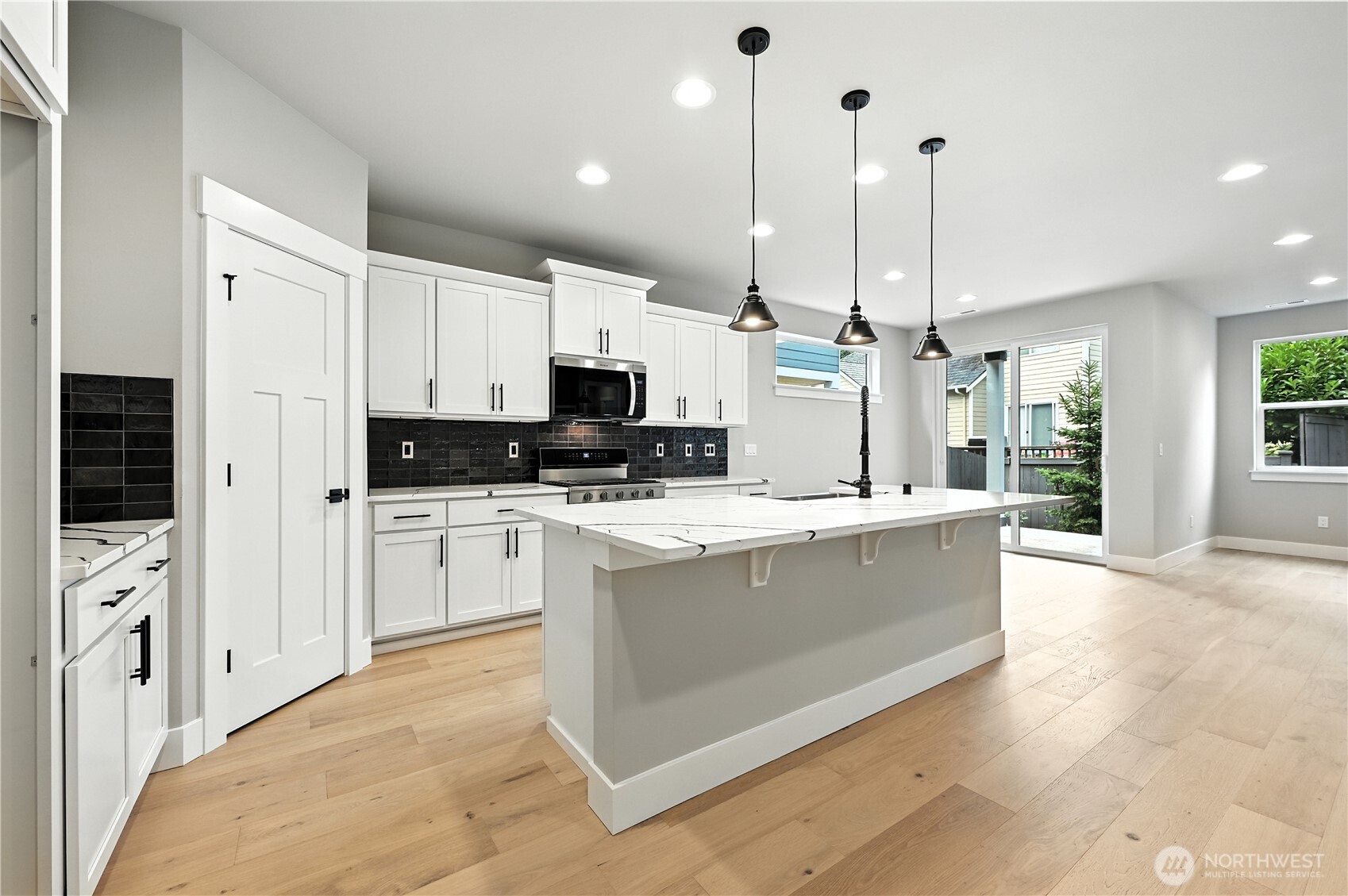 19225 Meridian Drive Southeast, Unit CW 15 Bothell, WA 98012 - Photo 5 of 31 a kitchen with stainless steel appliances kitchen island granite countertop a stove a sink and white cabinets