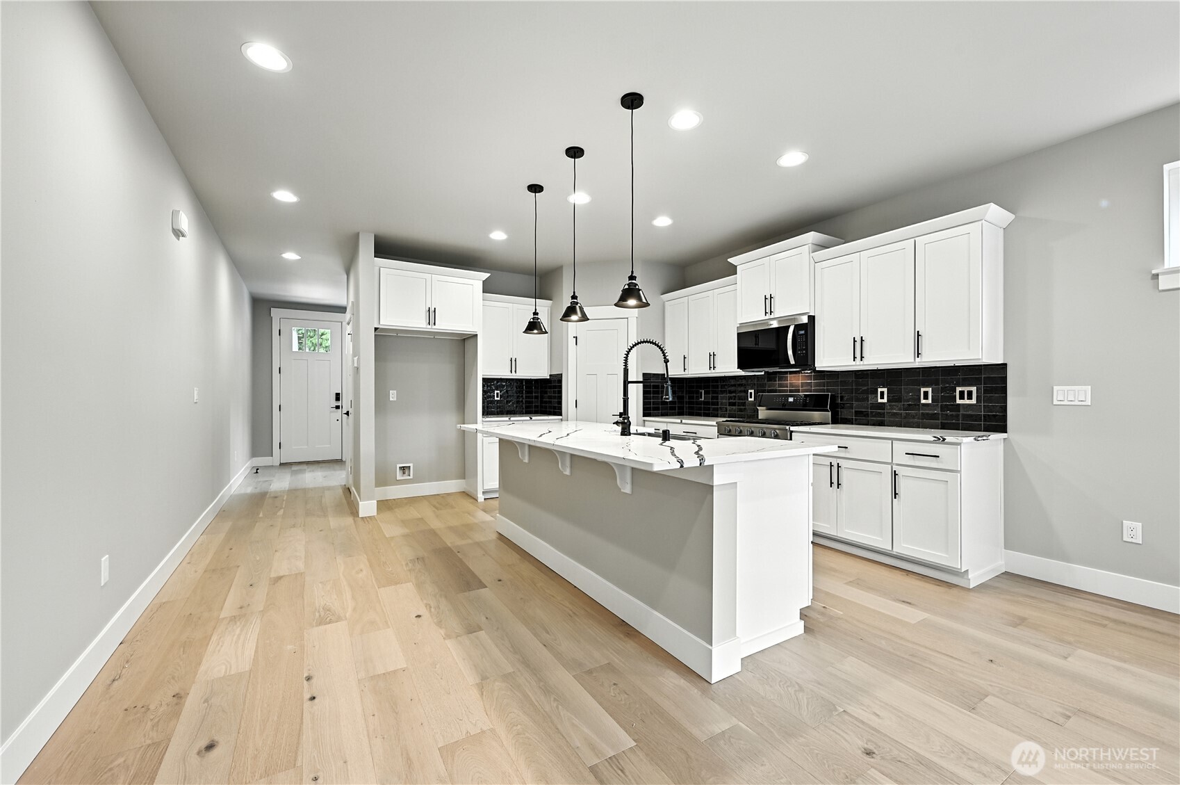 19225 Meridian Drive Southeast, Unit CW 15 Bothell, WA 98012 - Photo 6 of 31 a large white kitchen with lots of counter space a sink appliances and cabinets