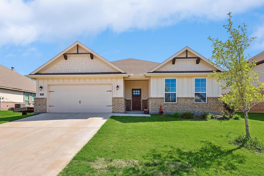 808 Feather Edge Drive Springtown, TX 76082 - Photo 2 of 40 a front view of a house with a yard and trees