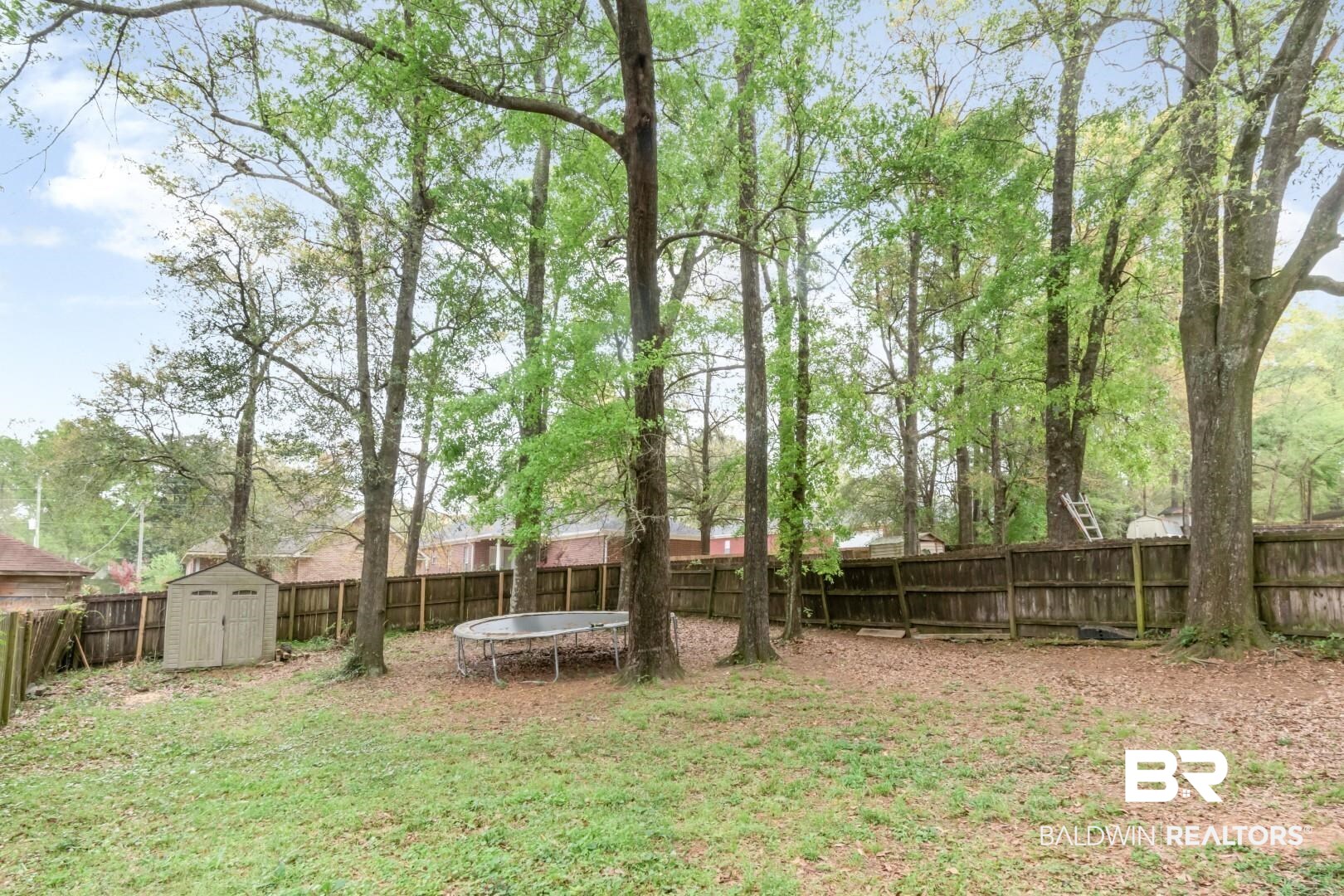 1065 Linlen Avenue Mobile, AL 36609 - Photo 25 of 31 View of yard with a fenced backyard, a storage unit, an outdoor structure, and a trampoline