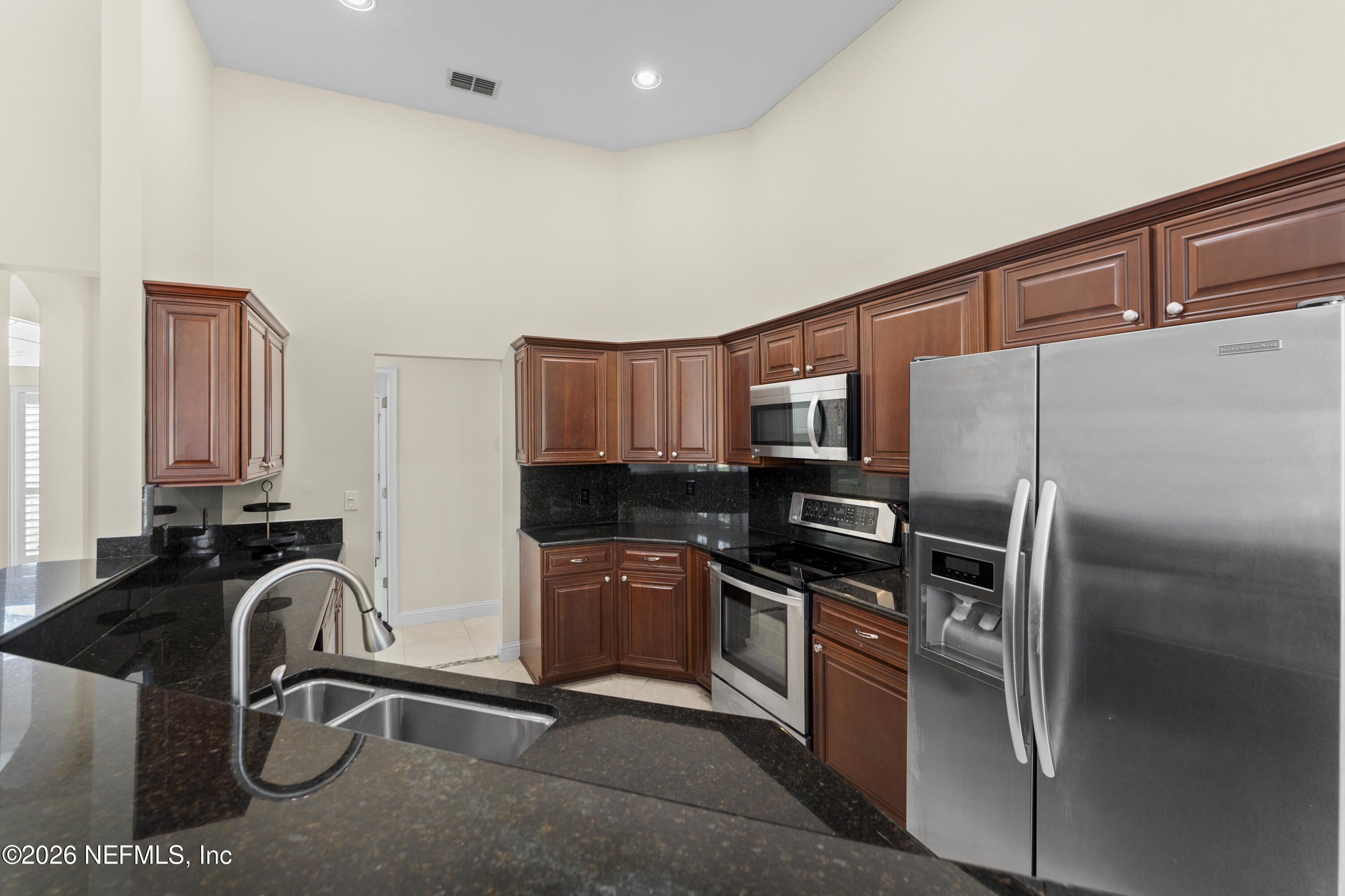 9957 Chelsea Lake Road Jacksonville, FL 32256 - Photo 16 of 73 a kitchen with stainless steel appliances granite countertop a sink stove and refrigerator