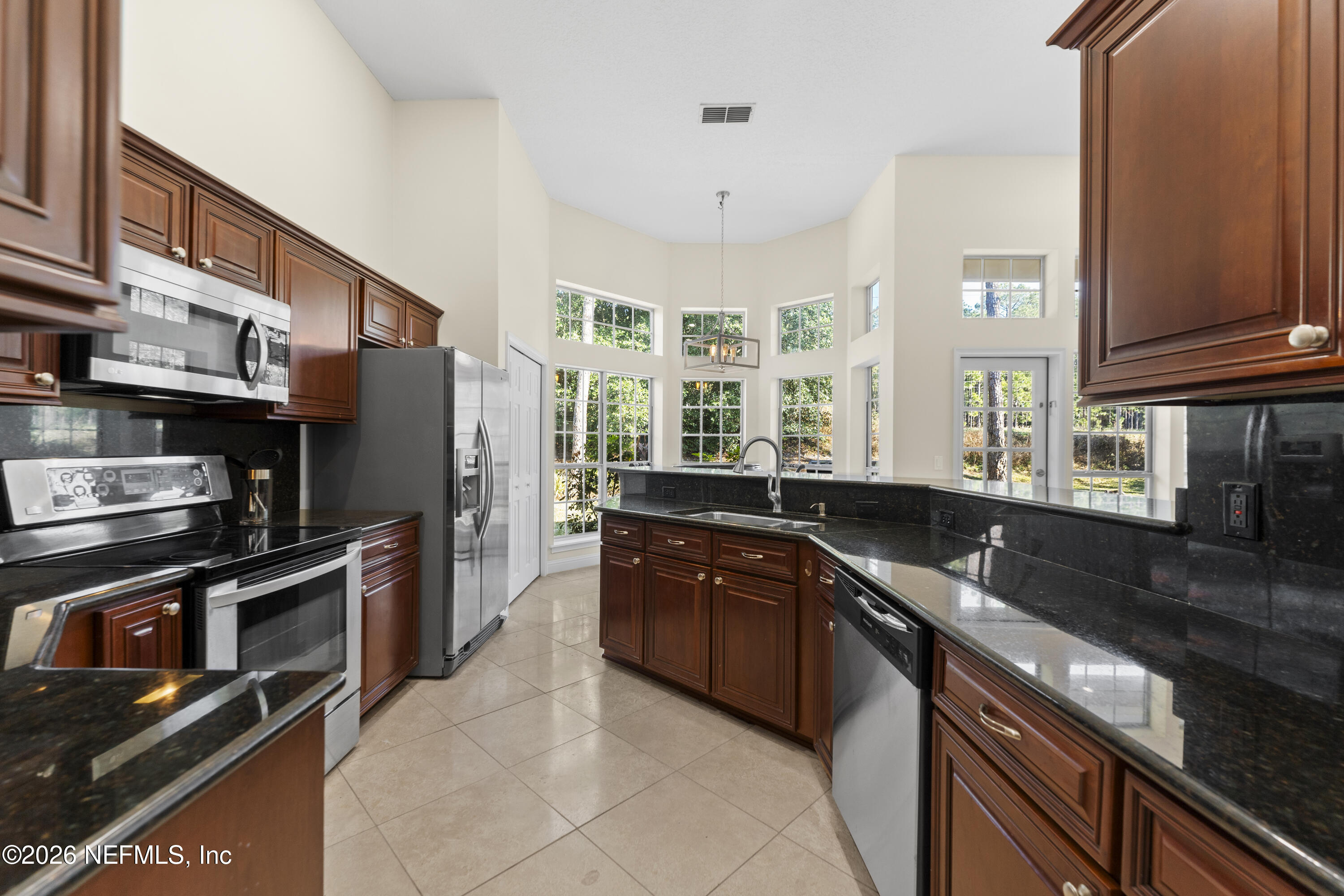 9957 Chelsea Lake Road Jacksonville, FL 32256 - Photo 19 of 73 a kitchen with stainless steel appliances granite countertop a sink stove and refrigerator
