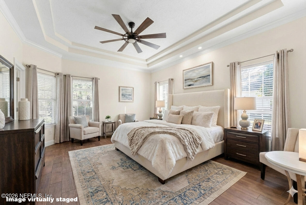 9957 Chelsea Lake Road Jacksonville, FL 32256 - Photo 22 of 73 a bedroom with a large bed a chandelier and windows