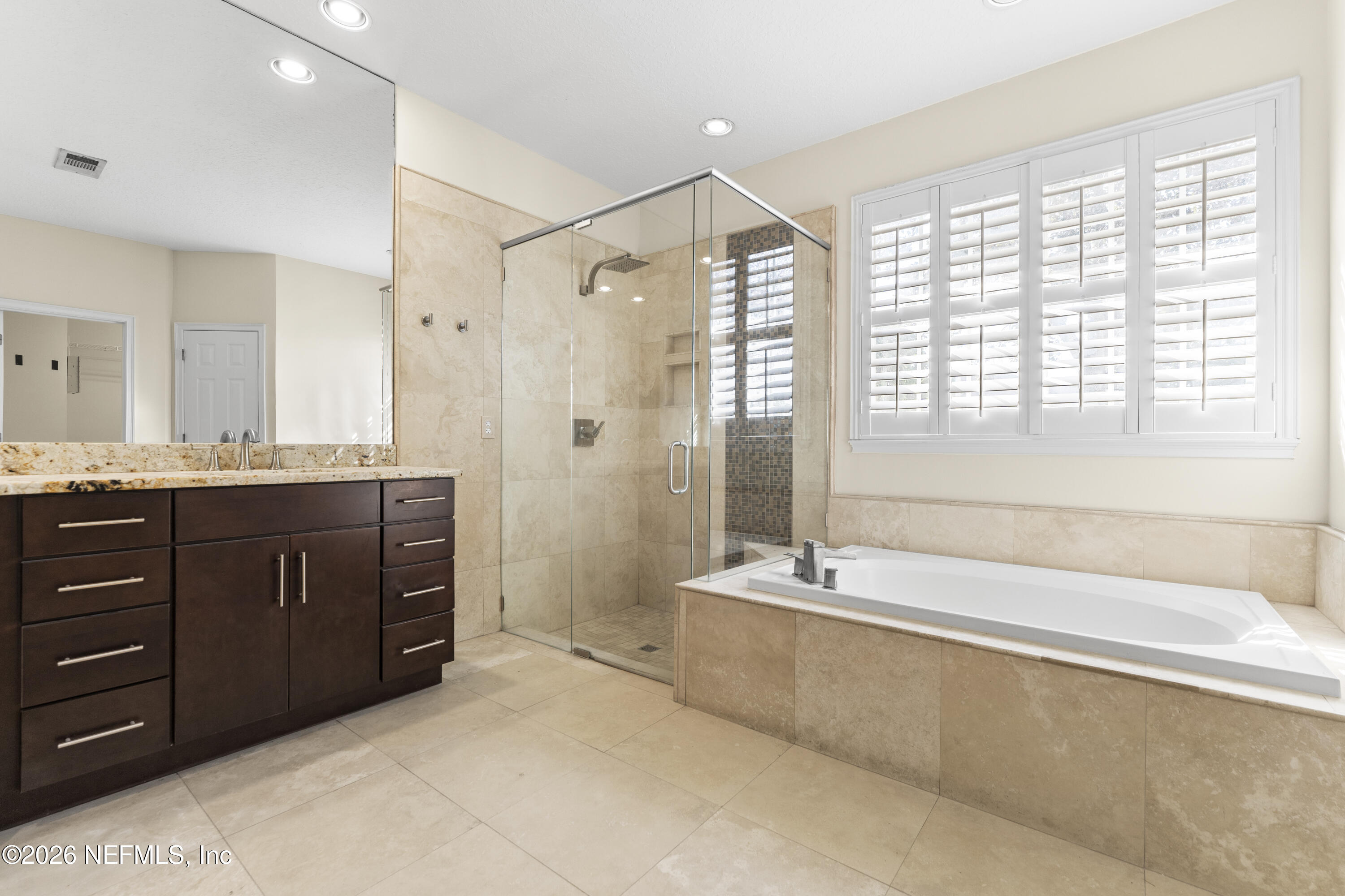 9957 Chelsea Lake Road Jacksonville, FL 32256 - Photo 26 of 73 a spacious bathroom with a tub sink and mirror
