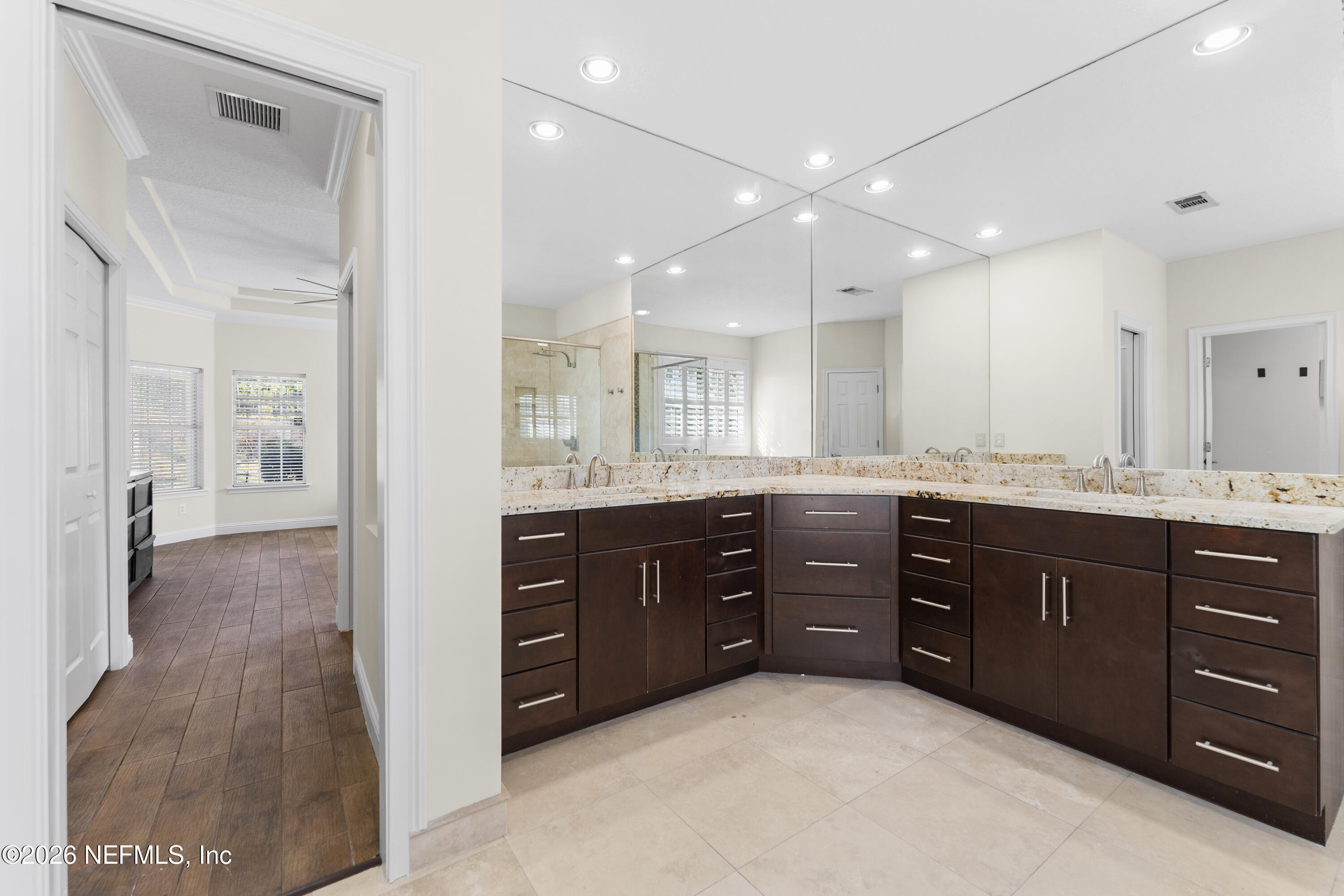 9957 Chelsea Lake Road Jacksonville, FL 32256 - Photo 27 of 73 a spacious bathroom with a vanity a sink a mirror and a shower