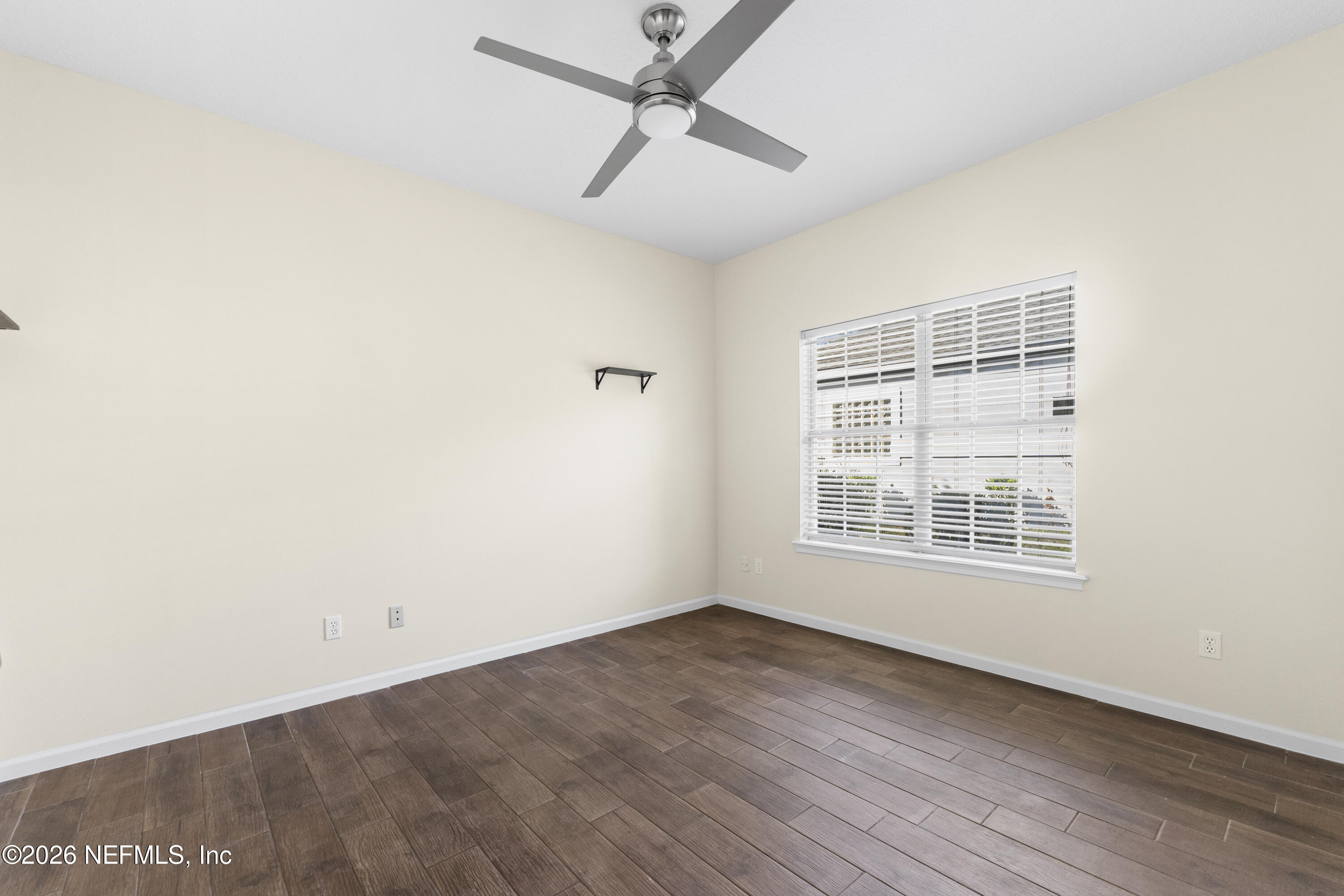 9957 Chelsea Lake Road Jacksonville, FL 32256 - Photo 30 of 73 an empty room with wooden floor ceiling fan and windows