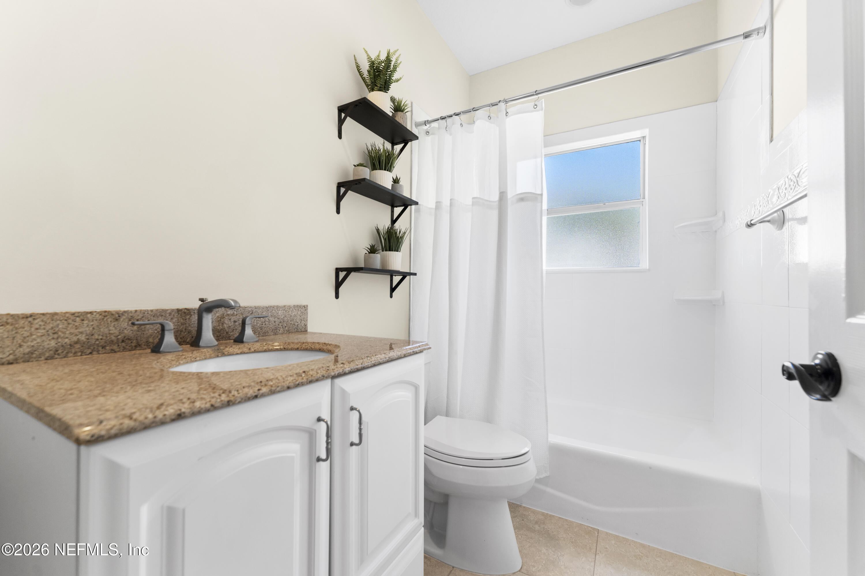 9957 Chelsea Lake Road Jacksonville, FL 32256 - Photo 32 of 73 a bathroom with a granite countertop sink toilet and shower