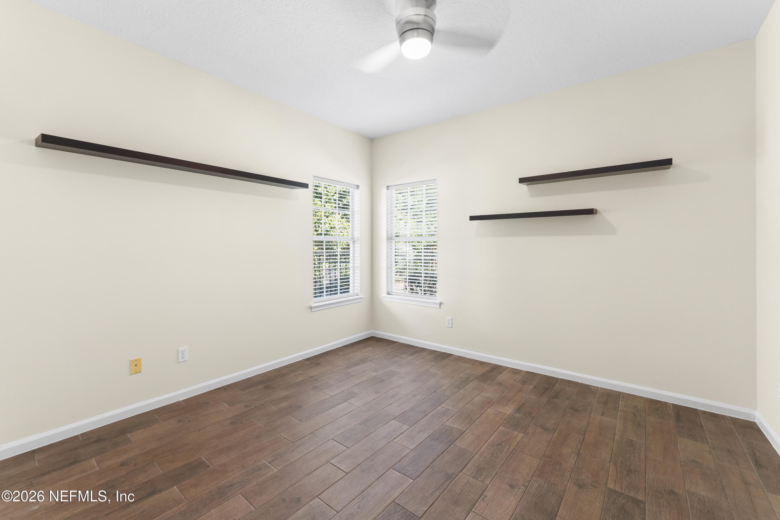 9957 Chelsea Lake Road Jacksonville, FL 32256 - Photo 33 of 73 an empty room with wooden floor and windows