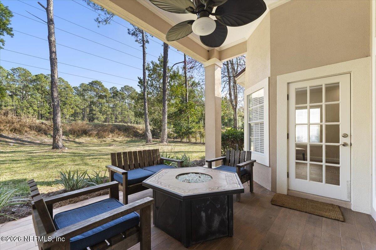 9957 Chelsea Lake Road Jacksonville, FL 32256 - Photo 35 of 73 a view of a patio with a table chairs and a swimming pool