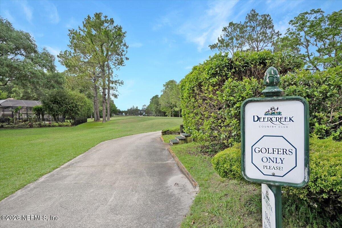 9957 Chelsea Lake Road Jacksonville, FL 32256 - Photo 42 of 73 a sign that is on a pole on a road