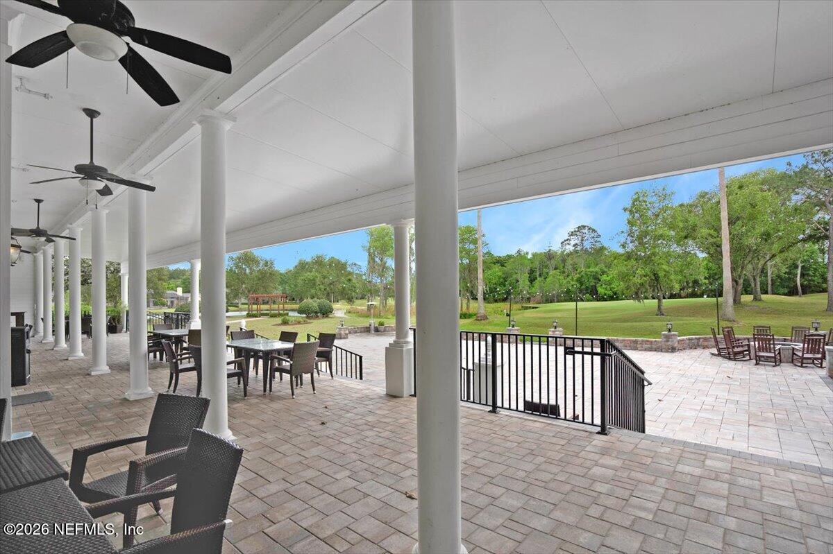 9957 Chelsea Lake Road Jacksonville, FL 32256 - Photo 59 of 73 a view of a patio with a dining table chairs and backyard