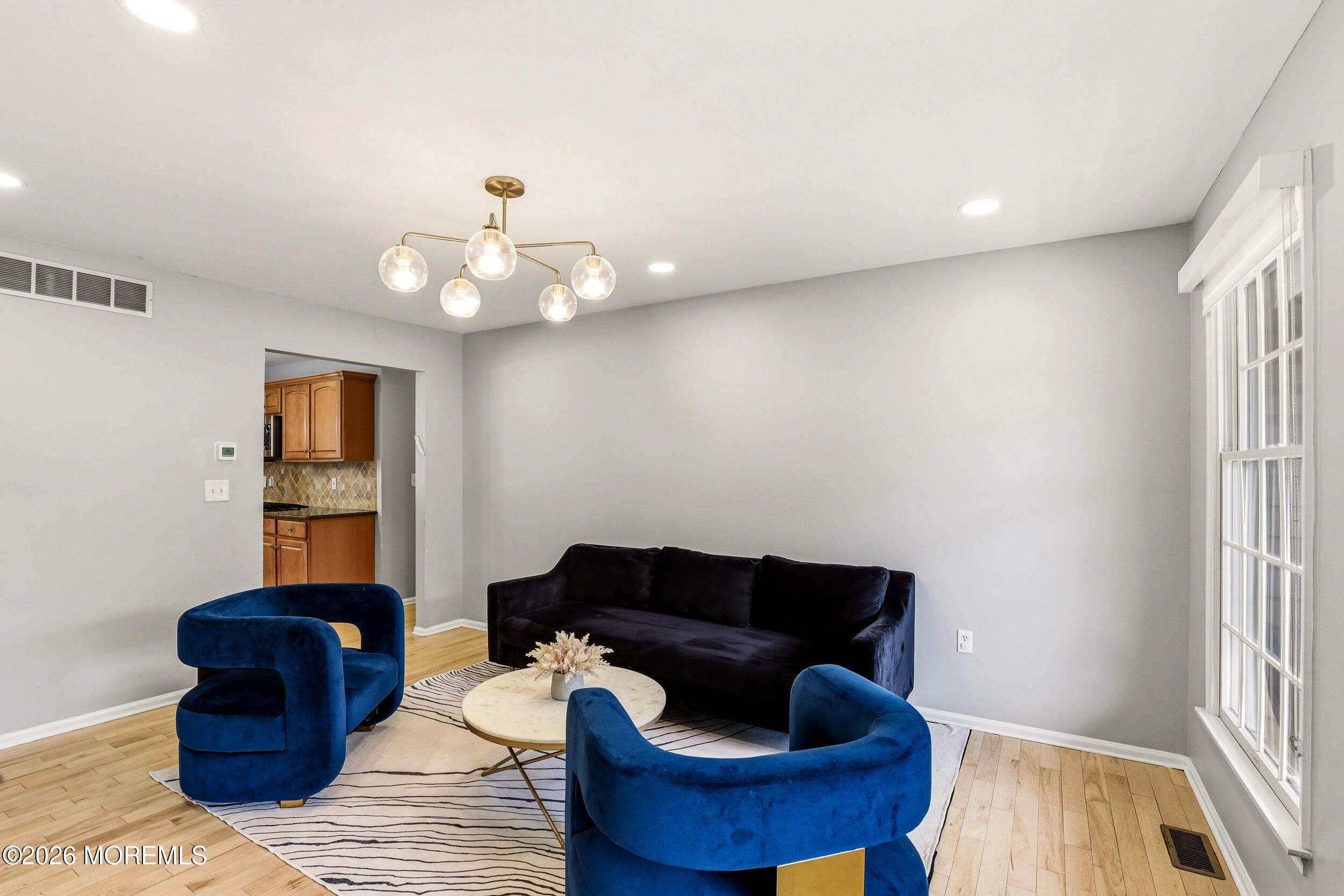 2055 MacKenzie Road Toms River, NJ 08755 - Photo 6 of 56 a living room with furniture and a chandelier