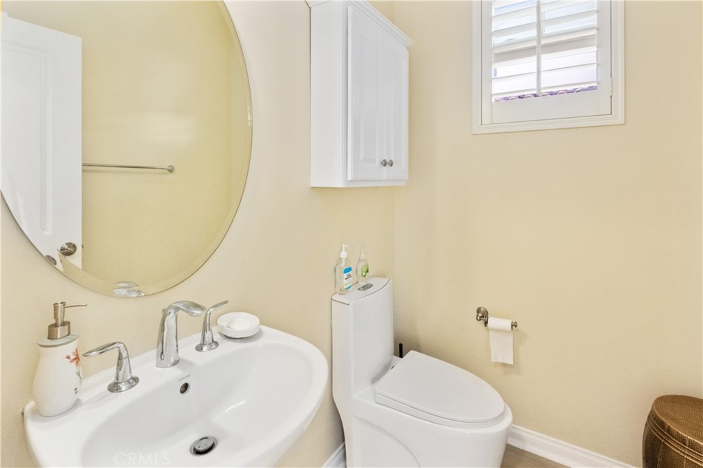 107 Overbrook Irvine, CA 92620 - Photo 14 of 47 a bathroom with a sink a toilet and mirror