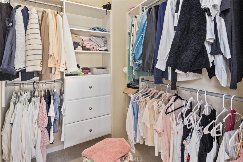 107 Overbrook Irvine, CA 92620 - Photo 19 of 47 a view of walk in closet with clothes and shoes