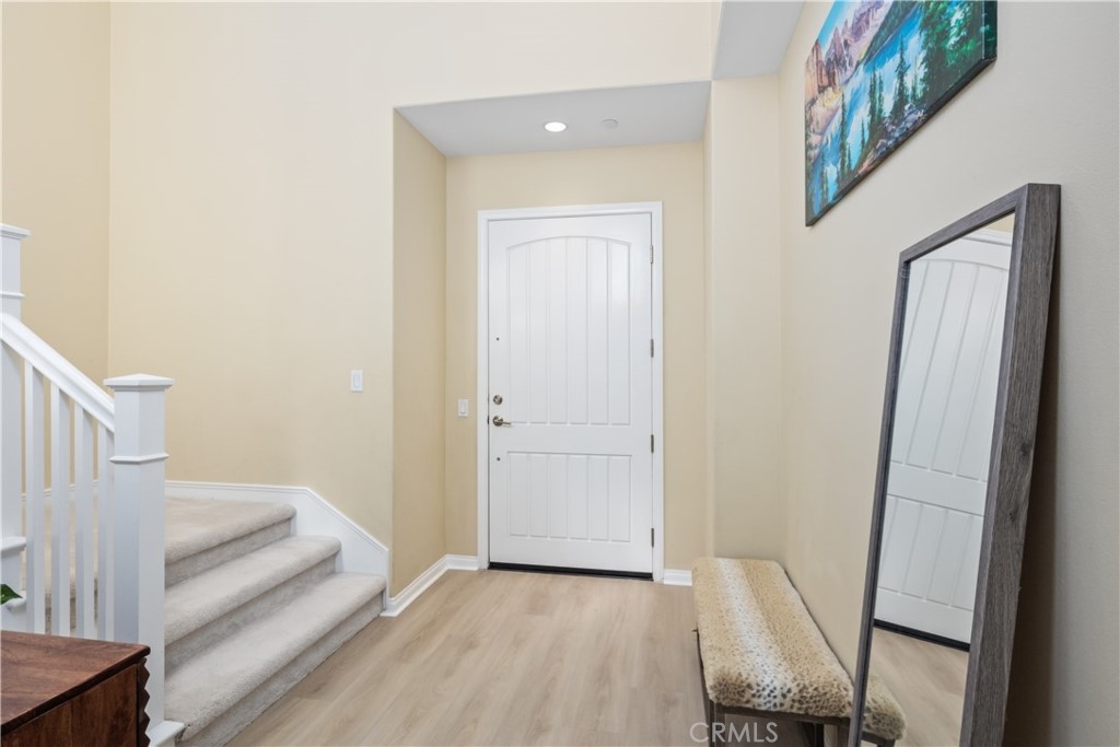 107 Overbrook Irvine, CA 92620 - Photo 3 of 47 a view of a hallway with entryway and wooden floor