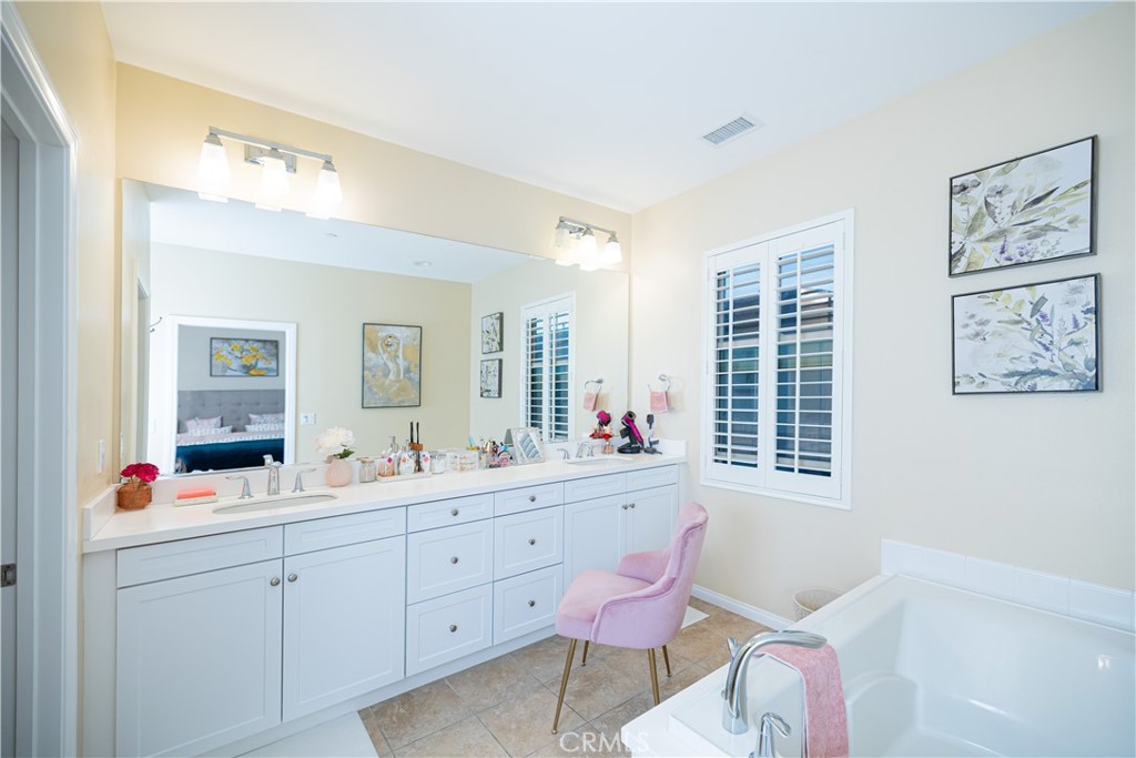 107 Overbrook Irvine, CA 92620 - Photo 39 of 47 a bathroom with a sink mirror and a bathtub