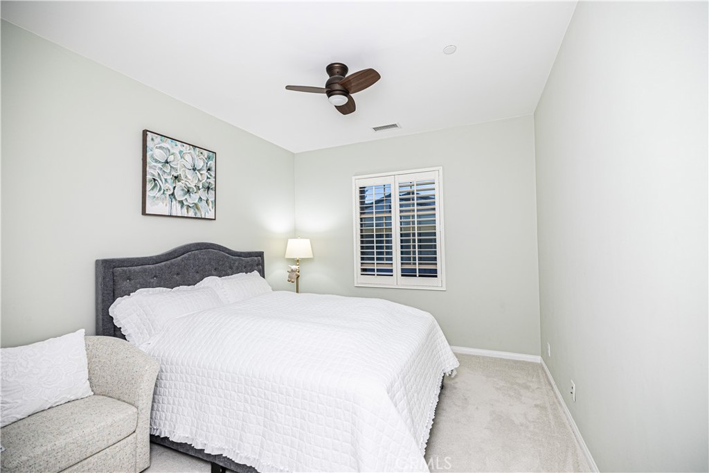 107 Overbrook Irvine, CA 92620 - Photo 40 of 47 a spacious bedroom with a bed and a couch