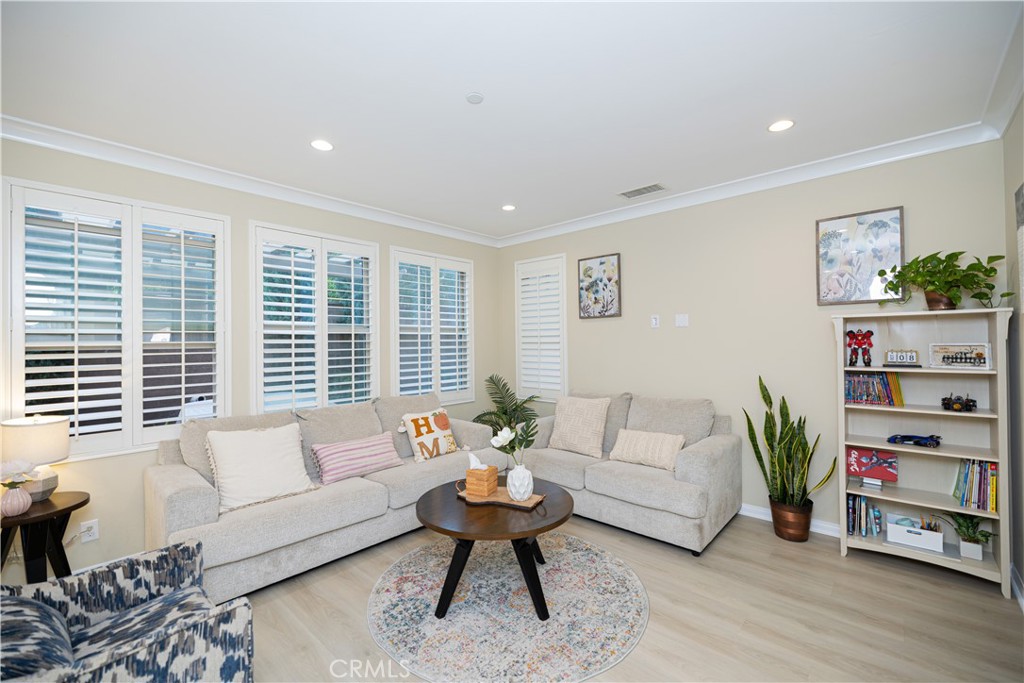 107 Overbrook Irvine, CA 92620 - Photo 4 of 47 a living room with furniture and a book shelf