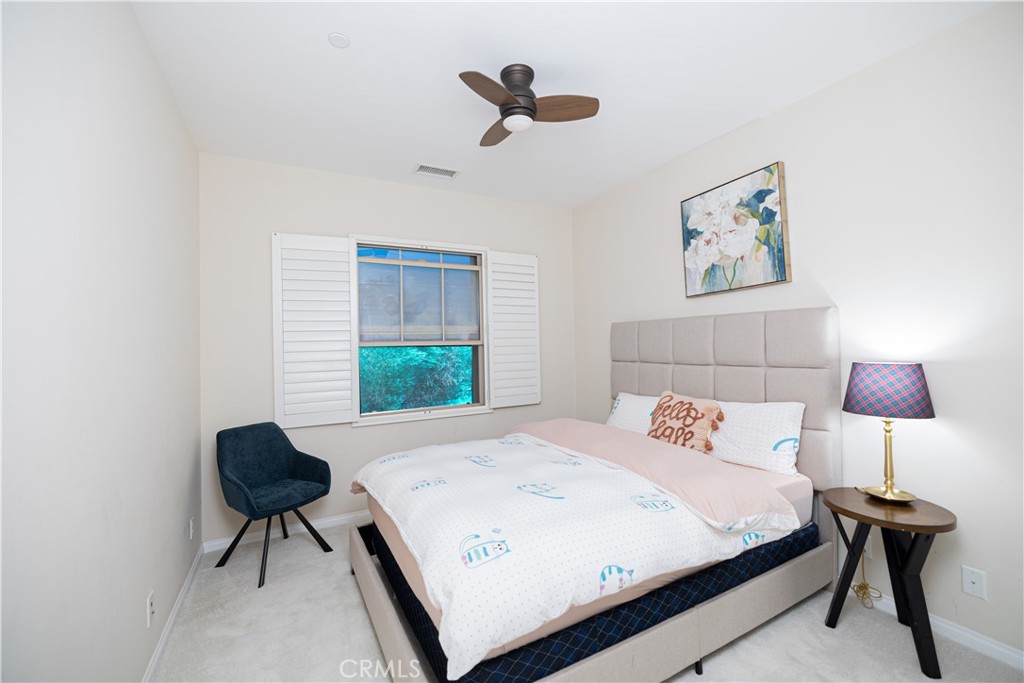 107 Overbrook Irvine, CA 92620 - Photo 44 of 47 a bedroom with a bed and a chandelier