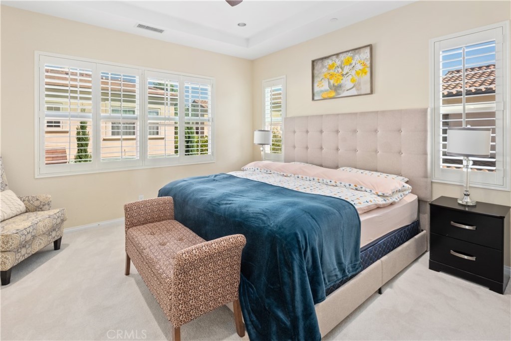 107 Overbrook Irvine, CA 92620 - Photo 9 of 47 a bedroom with a bed and a couch