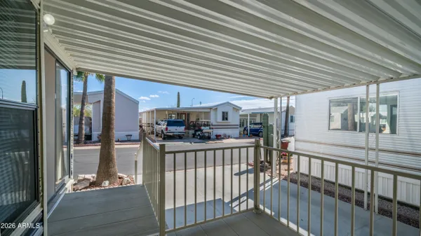 a living room with furniture a large window and a chandelier