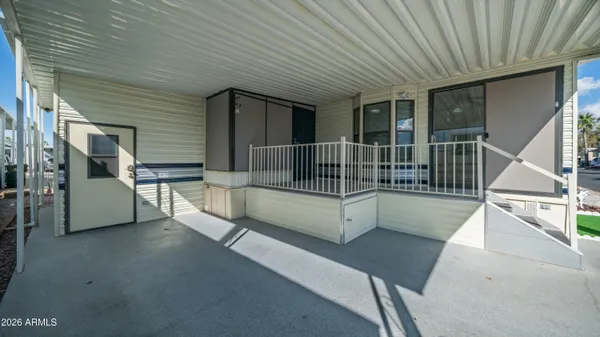 a view of a balcony with chairs and wooden floor