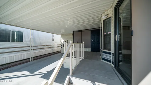 a view of a balcony with wooden floor and stairs