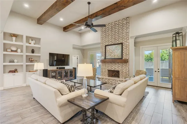 a living room with furniture a fireplace and a flat screen tv