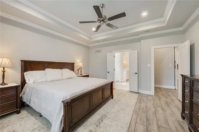 a bedroom with a bed and a ceiling fan