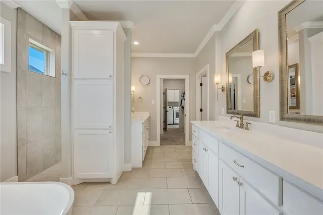 a spacious bathroom with a double vanity sink a toilet and a shower