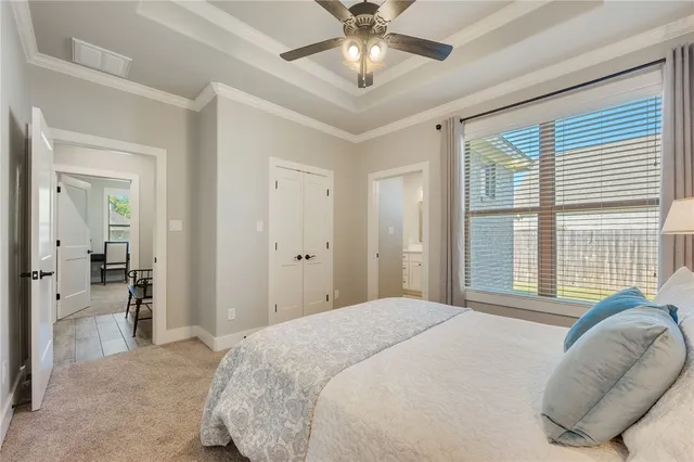 a bedroom with a bed and a large window