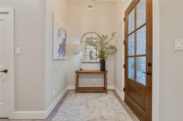 a view of an entryway with wooden floor