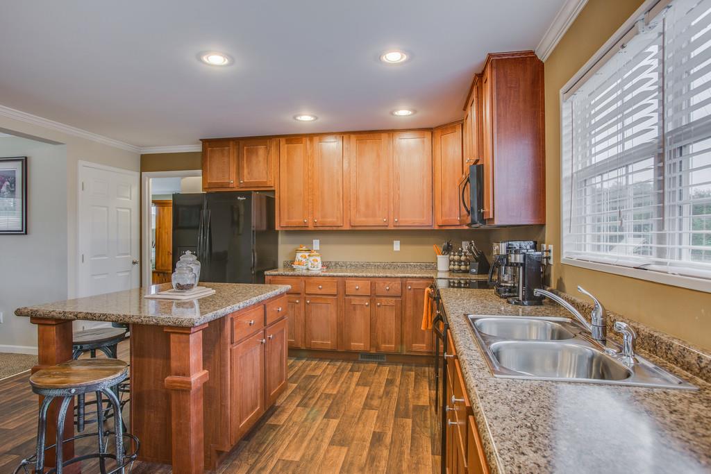 1142 Wrights Mill Road Spring Hill, TN 37174 - Photo 12 of 30 a kitchen with stainless steel appliances granite countertop a sink a stove and a refrigerator