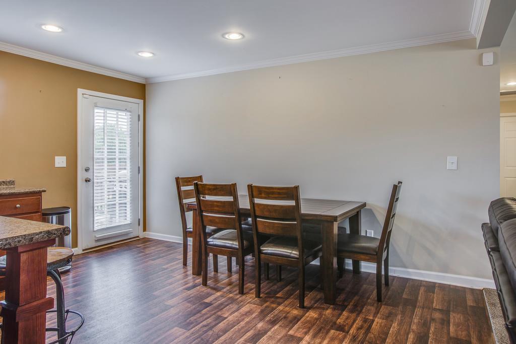 1142 Wrights Mill Road Spring Hill, TN 37174 - Photo 14 of 30 a view of a dining room with furniture and wooden floor